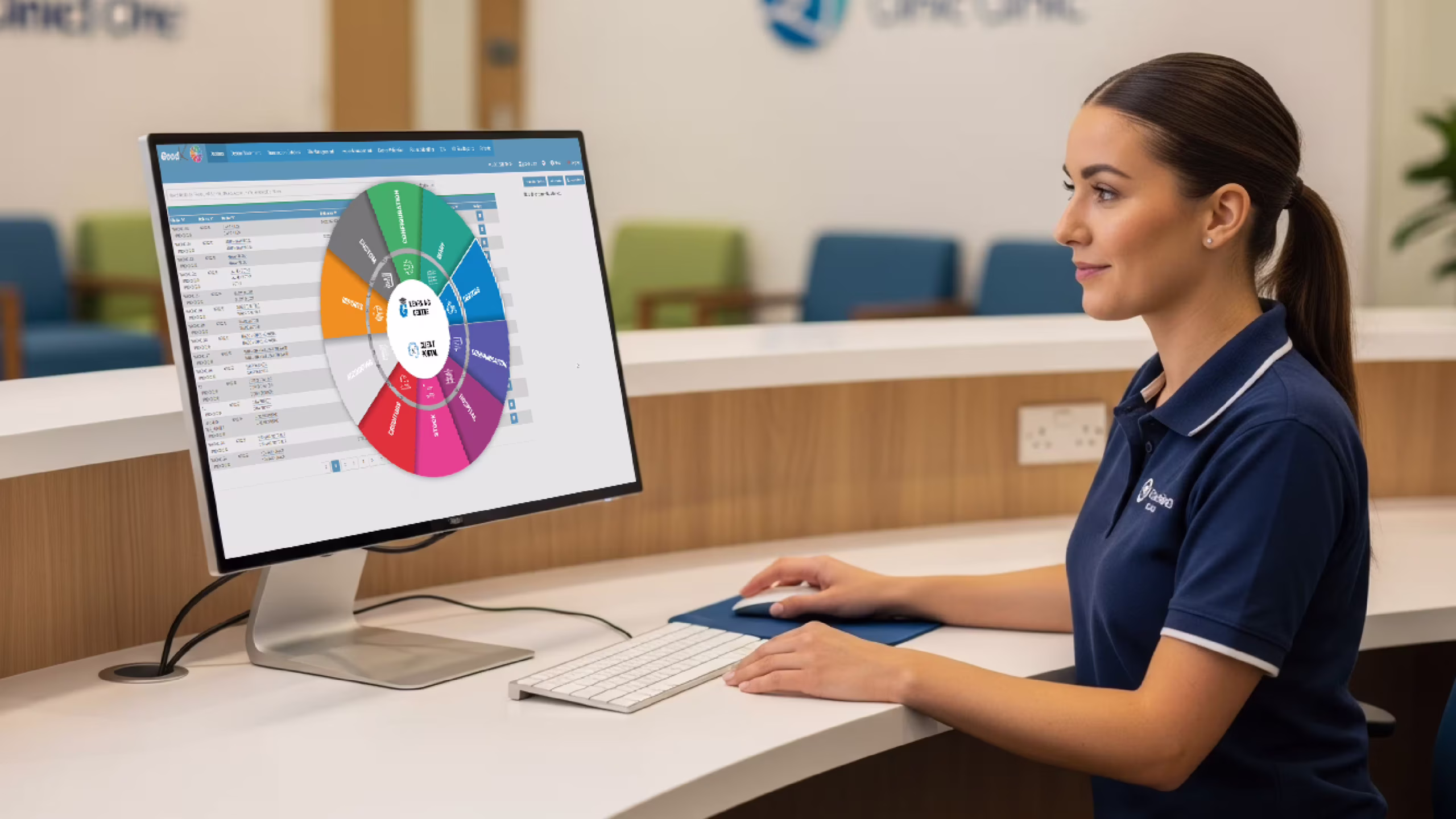 Receptionist in UK clinic using practice management software on screen