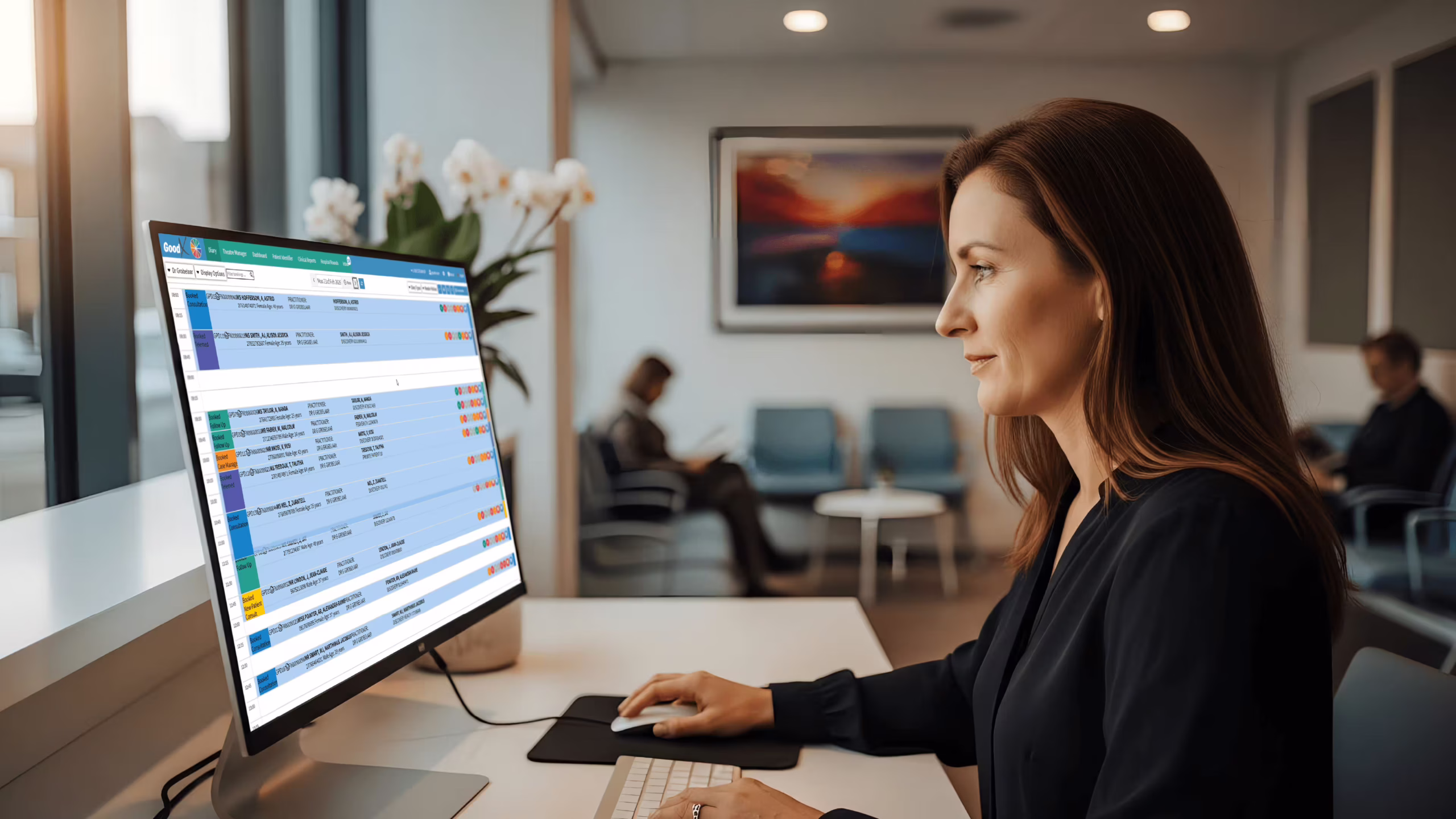 UK healthcare administrator using the best scheduling software for healthcare at clinic reception desk